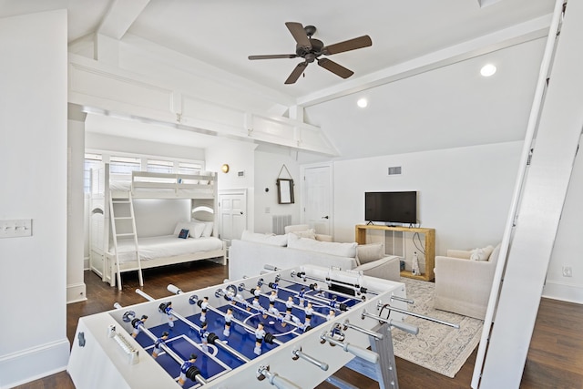 bedroom with dark wood-type flooring, ceiling fan, and vaulted ceiling with beams