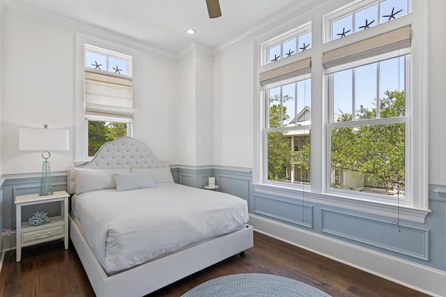 bedroom with crown molding, dark hardwood / wood-style floors, and ceiling fan