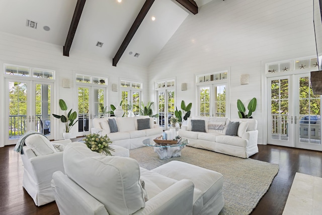 sunroom featuring plenty of natural light, lofted ceiling with beams, and french doors