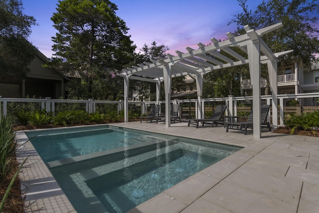 pool at dusk with a pergola and a patio