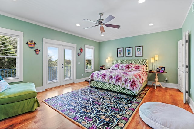 bedroom with access to outside, crown molding, and multiple windows