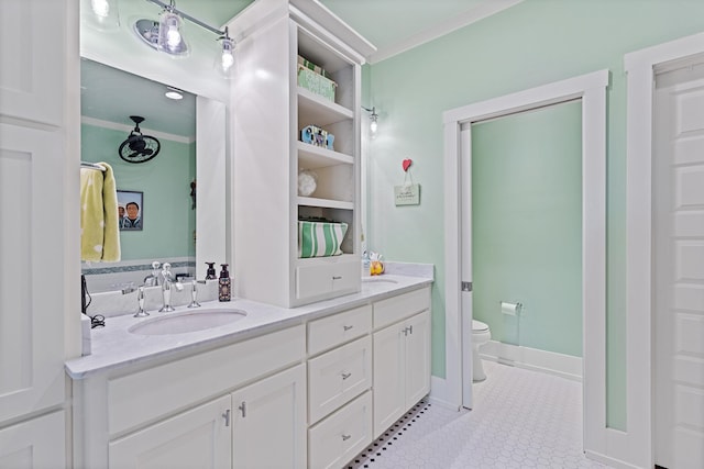 bathroom with ornamental molding, vanity, toilet, and tile patterned floors
