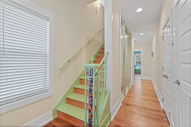 hallway with light hardwood / wood-style floors