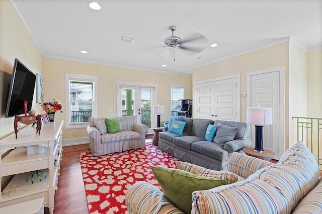 living room featuring crown molding, dark wood-type flooring, and ceiling fan