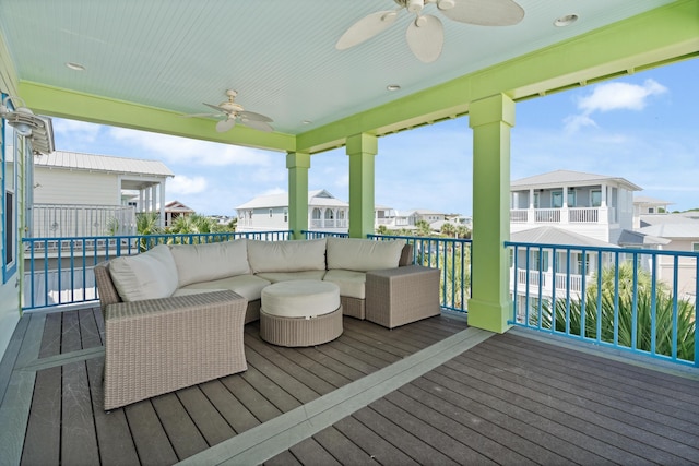 wooden deck featuring an outdoor living space and ceiling fan