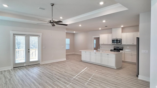 kitchen with open floor plan, stainless steel appliances, visible vents, and a sink