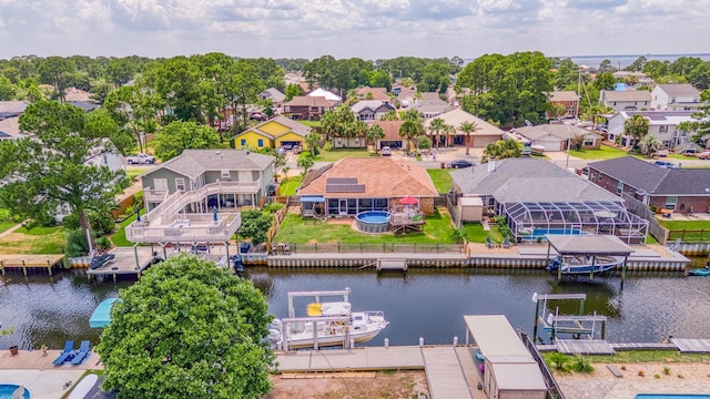 birds eye view of property with a water view and a residential view