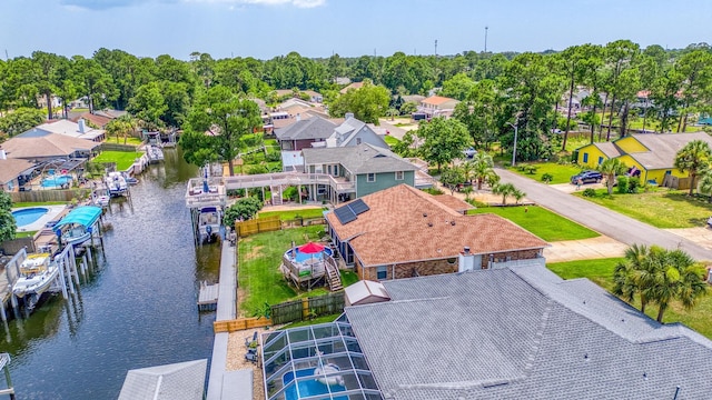 drone / aerial view with a water view and a residential view