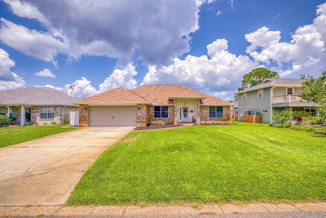 view of front of home featuring a garage, driveway, and a front lawn