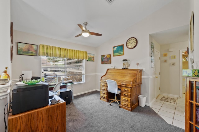 office area featuring lofted ceiling, carpet, a ceiling fan, and tile patterned floors