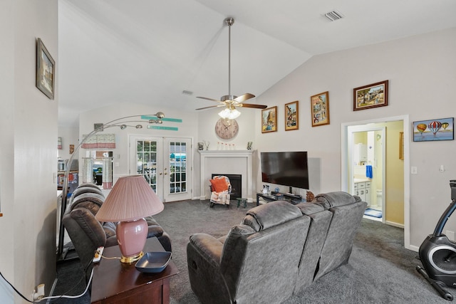 living room with vaulted ceiling, french doors, carpet flooring, and a fireplace