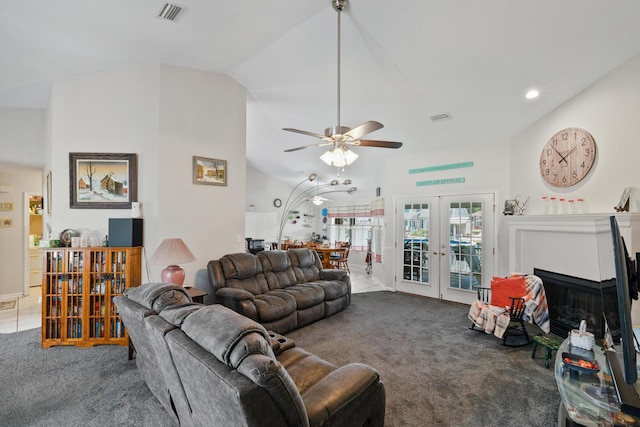 living area featuring lofted ceiling, french doors, visible vents, and dark carpet