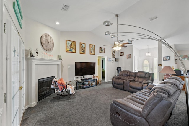 living room featuring lofted ceiling, carpet floors, a tile fireplace, and visible vents