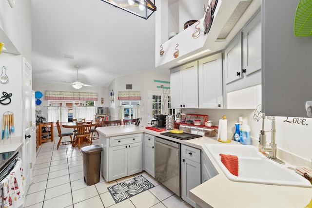 kitchen with ceiling fan, a peninsula, a sink, light countertops, and stainless steel dishwasher