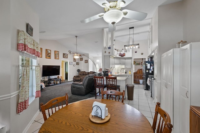 dining space with visible vents, high vaulted ceiling, light tile patterned flooring, and a ceiling fan