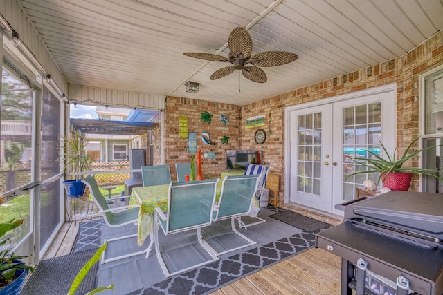 sunroom / solarium with french doors and a ceiling fan