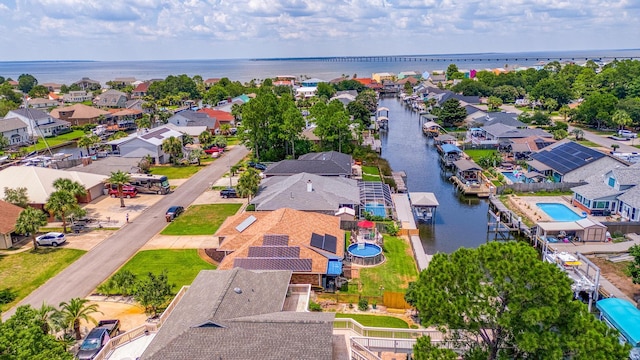 drone / aerial view with a residential view and a water view