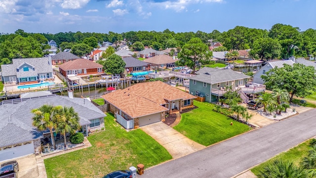 drone / aerial view featuring a residential view and a water view