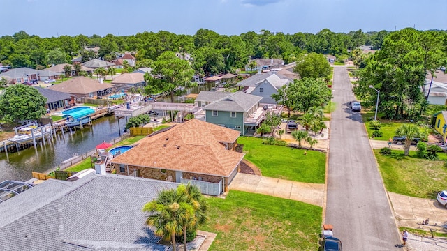 drone / aerial view featuring a water view and a residential view