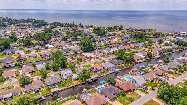 drone / aerial view with a water view and a residential view