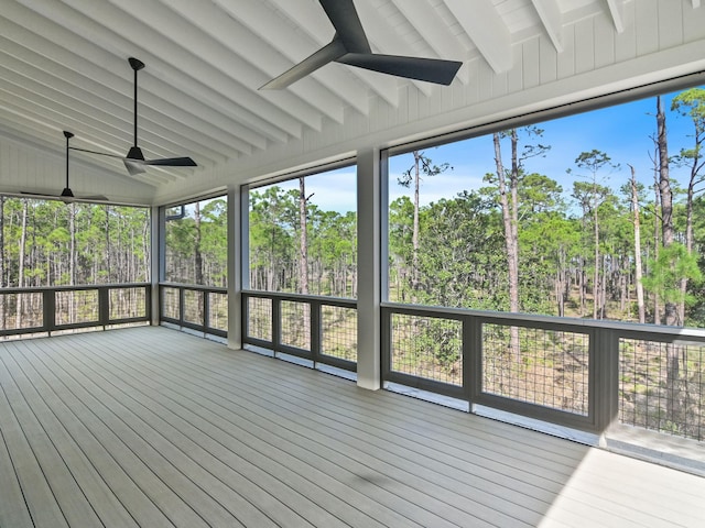 unfurnished sunroom with lofted ceiling with beams and ceiling fan