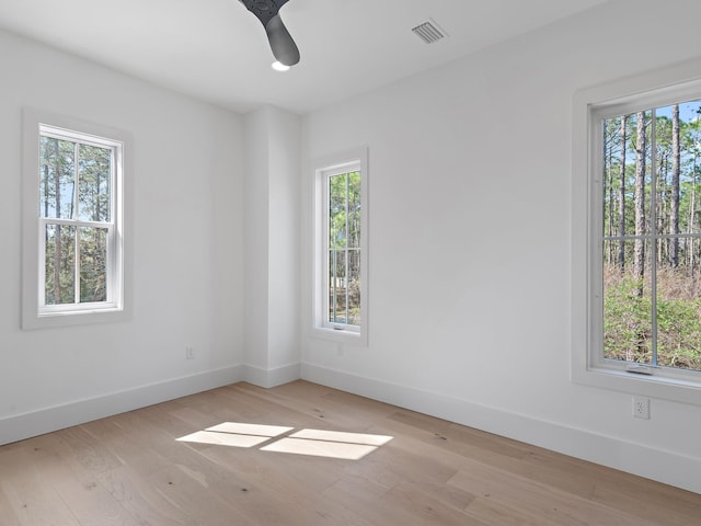 unfurnished room with ceiling fan and light hardwood / wood-style floors