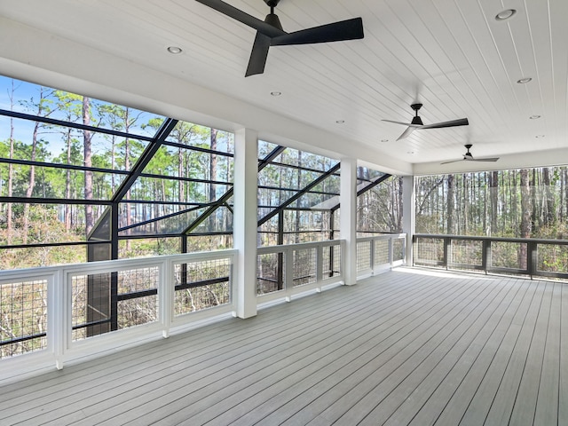 unfurnished sunroom featuring ceiling fan