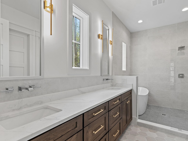 bathroom with vanity, tile patterned floors, and plus walk in shower