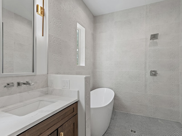 bathroom with vanity, shower with separate bathtub, tile walls, and backsplash