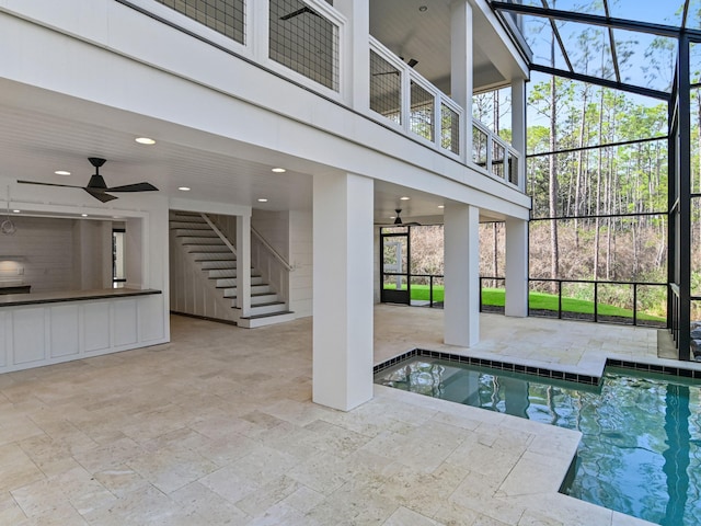 view of pool featuring a patio, ceiling fan, and glass enclosure