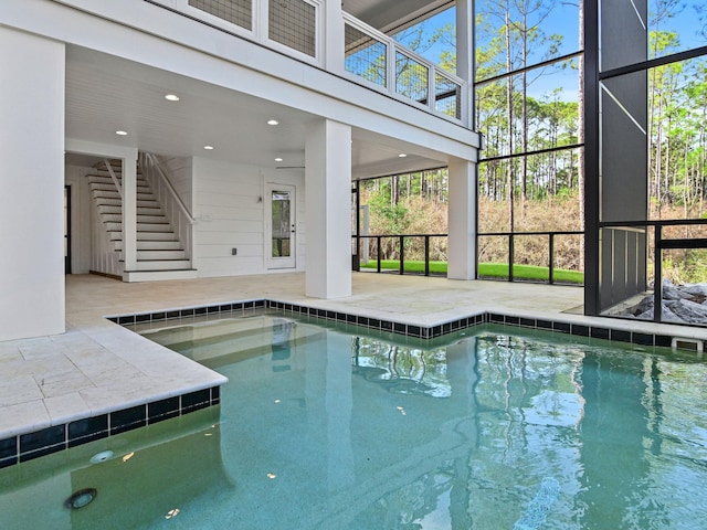 view of swimming pool featuring a lanai and a patio