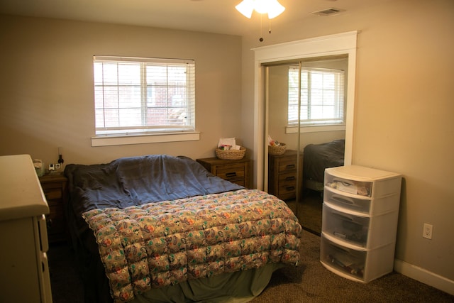 bedroom featuring dark carpet and a closet