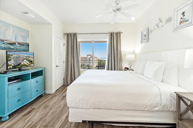 bedroom with ceiling fan, light hardwood / wood-style flooring, and access to outside