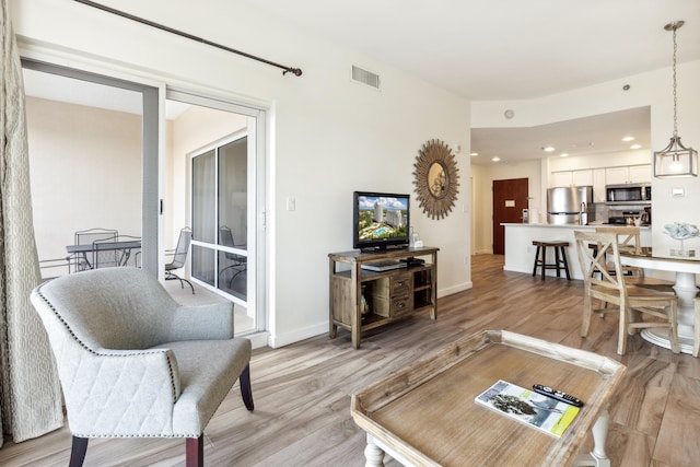 living room with light hardwood / wood-style flooring