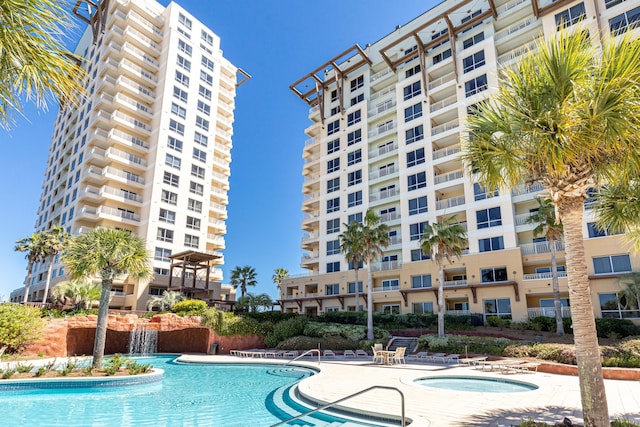 view of swimming pool featuring a patio, a hot tub, and pool water feature