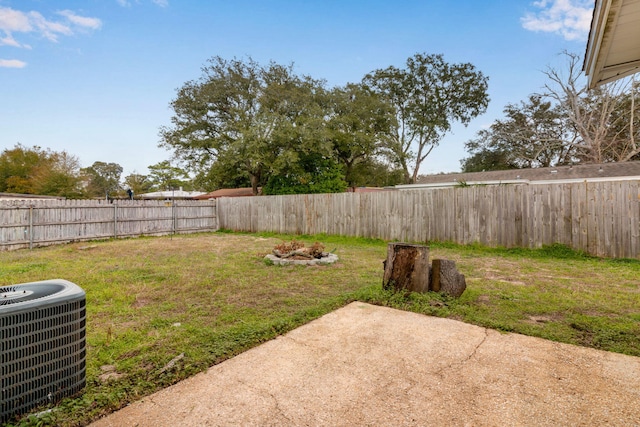 view of yard featuring central AC unit, a patio area, and a fenced backyard