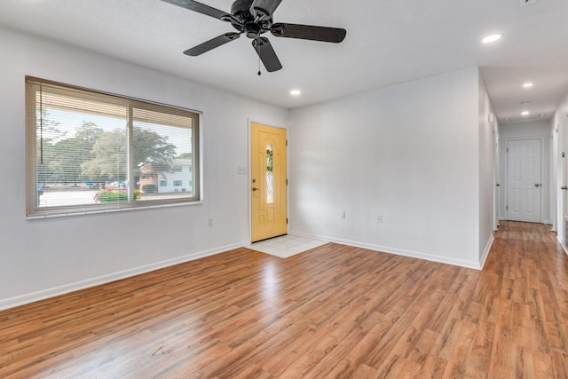 spare room featuring ceiling fan, recessed lighting, light wood-type flooring, and baseboards