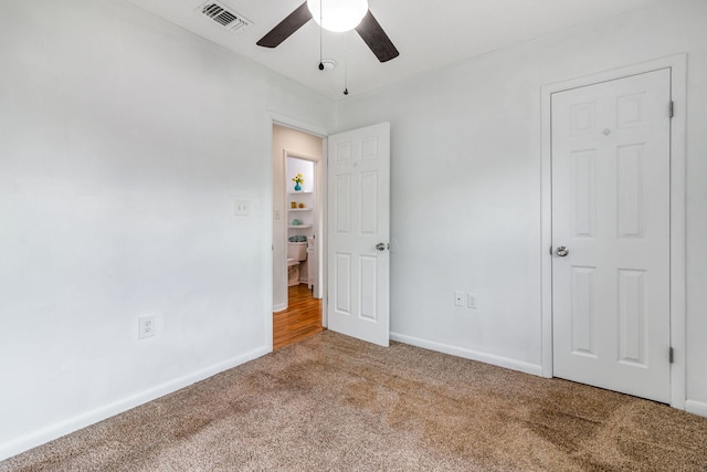 unfurnished bedroom with ceiling fan, carpet floors, visible vents, and baseboards