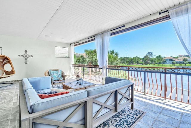 view of patio / terrace featuring a water view and an outdoor living space with a fire pit