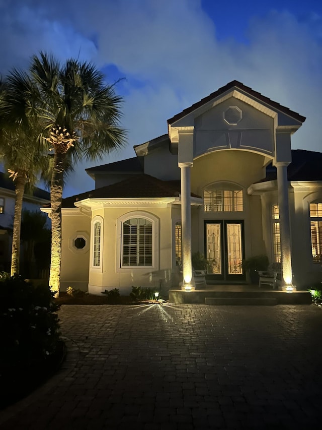 503 Regatta Bay Blvd, Destin, FL 32541 - back of house at twilight featuring french doors and stucco siding
