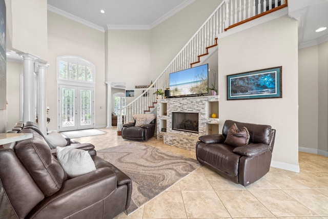 503 Regatta Bay Blvd, Destin, FL 32541 - tiled living room featuring a towering ceiling, stairway, ornamental molding, a fireplace, and ornate columns