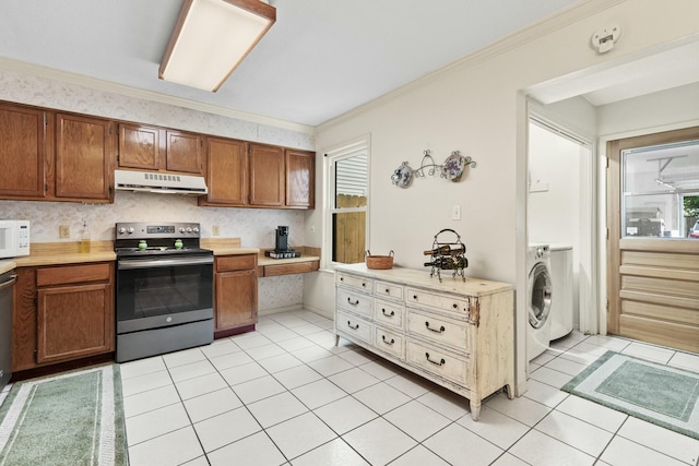 kitchen featuring light tile patterned flooring, ornamental molding, washer / dryer, and electric range