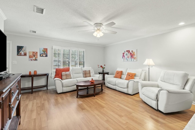 living room with crown molding, ceiling fan, light hardwood / wood-style floors, and a textured ceiling