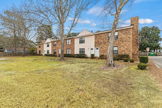 rear view of house featuring a lawn