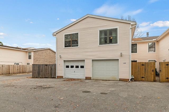 rear view of property featuring a garage