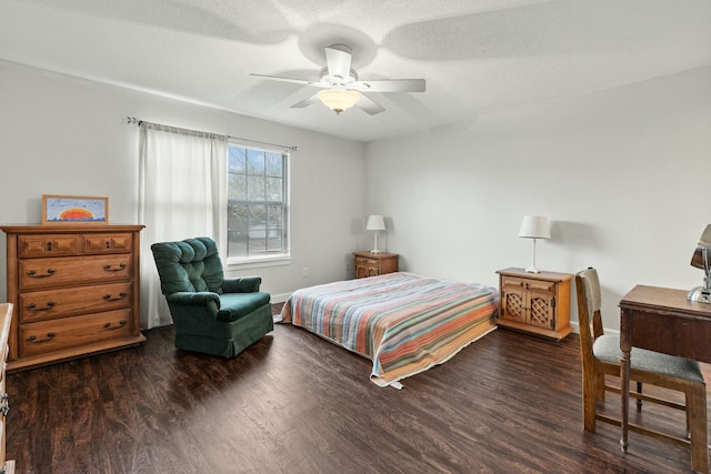 bedroom featuring ceiling fan, a textured ceiling, and dark hardwood / wood-style flooring