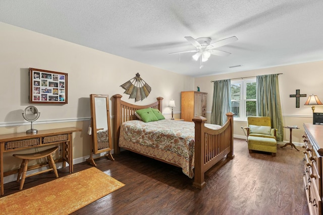 bedroom featuring ceiling fan, dark hardwood / wood-style flooring, and a textured ceiling