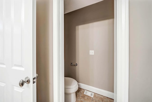 bathroom with tile patterned flooring and toilet