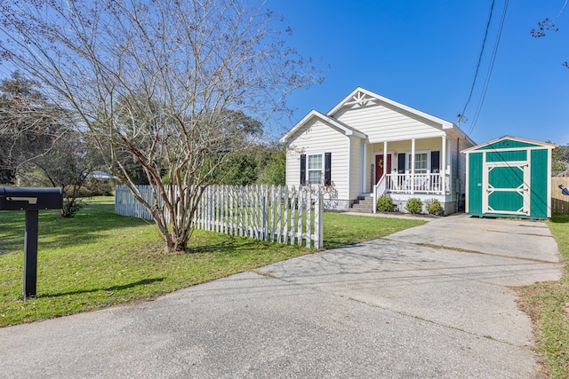 view of front of property with a shed, covered porch, and a front lawn