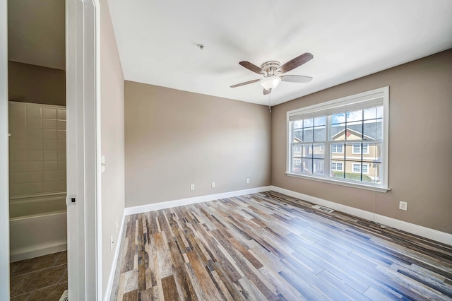 unfurnished room featuring hardwood / wood-style flooring and ceiling fan
